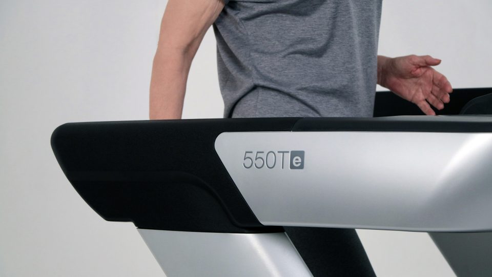 a man is walking on a tread machine